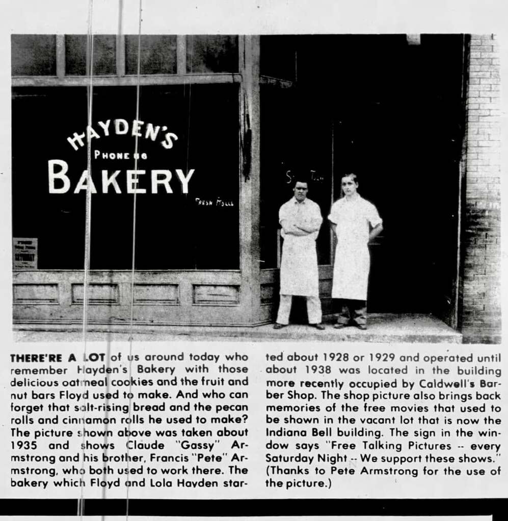 Storefront of Hayden's Bakery with the two owners standing in front of the doors in long white aprons