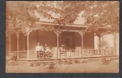 Front Porch of House with Two People in Chairs